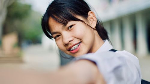 Close-up portrait of smiling young woman