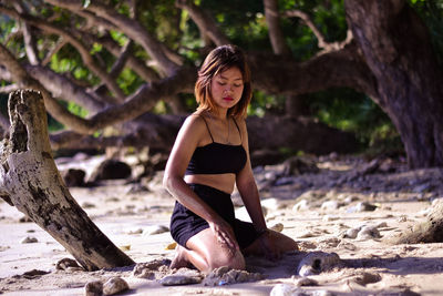 Portrait of woman sitting on sand