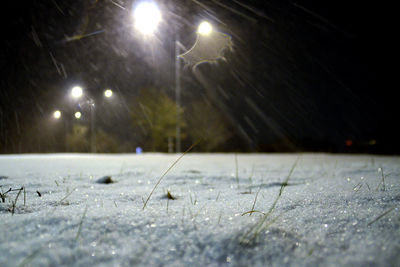 Illuminated field against sky at night during winter