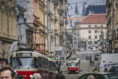 Cars on city street by buildings