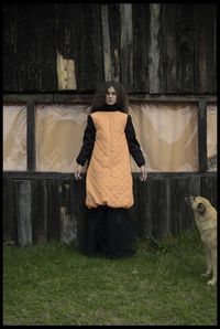 Portrait of woman standing against plants