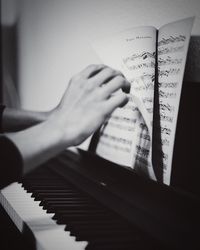 Cropped hands of woman holding sheet music