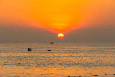 Scenic view of sea against orange sky