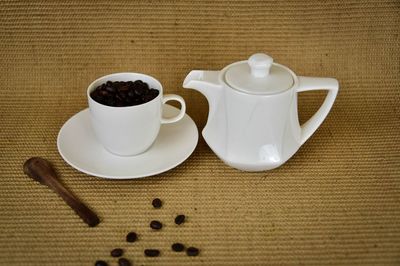 Coffee cup and spoon on table