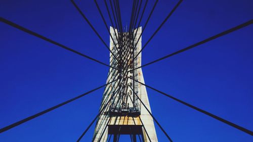 Low angle view of cables against blue sky