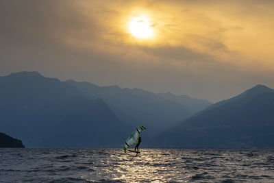 Kitesurfing scene at sunset on lake como