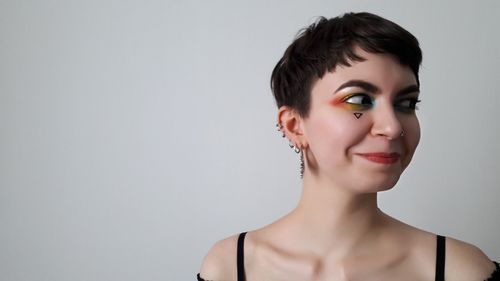 Portrait of young woman against white background