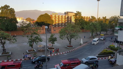 Cars on street in city against sky