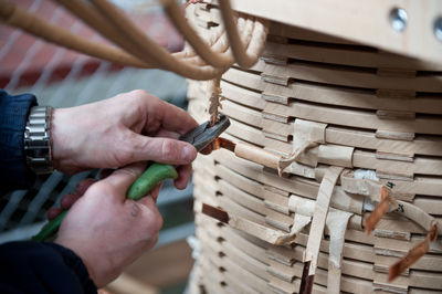 Cropped image of man cutting cable