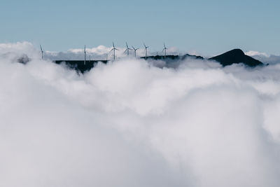 Low angle view of snowcapped mountains against sky