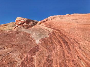 Scenic view of desert against clear blue sky