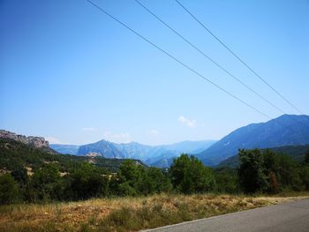 Scenic view of mountains against clear blue sky