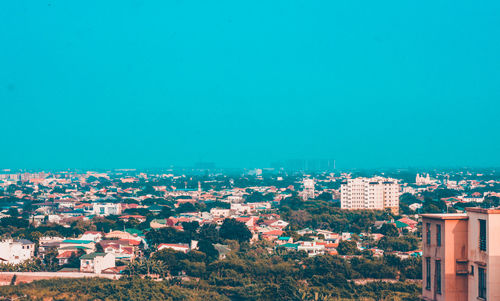 Cityscape against clear blue sky