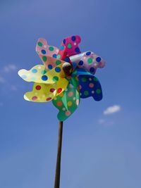 Low angle view of colorful balloons against blue sky