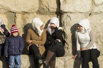 Group of people standing against the wall