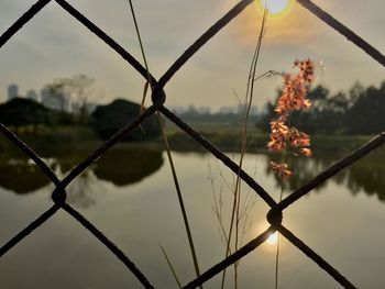 Close-up of chainlink fence against sky
