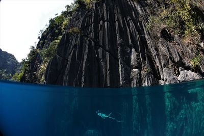 Side view of person swimming undersea