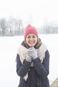 Portrait of smiling man standing in snow