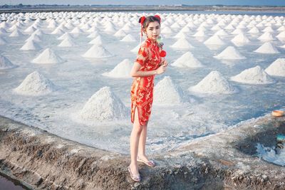 Full length portrait of woman standing outdoors