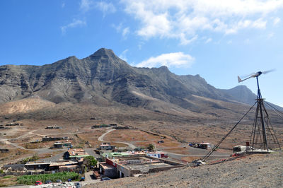 Windmill against mountains