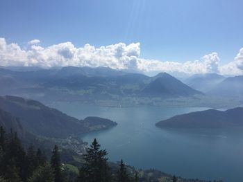 Scenic view of lake and mountains against blue sky