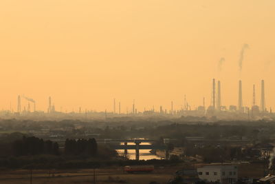 View of factory against sky during sunset
