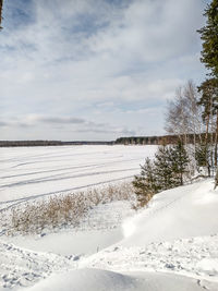 Scenic view of snow covered landscape against sky