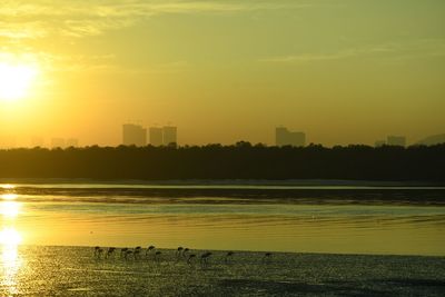 Scenic view of lake against sky during sunset