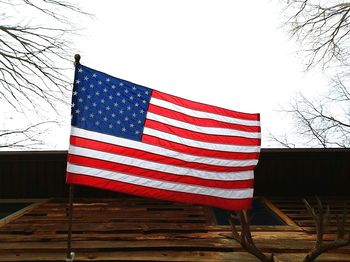 Low angle view of flag against clear sky