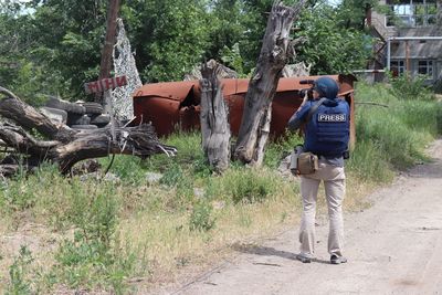 Rear view of man standing in forest