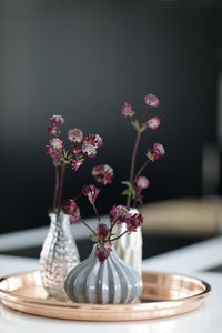 Close-up of purple flower vase on table