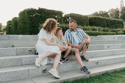 Side view of couple sitting on steps