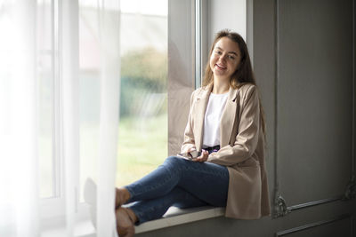 Solace in city, amidst the hustle of city life, moment of solace is captured as she sits by window