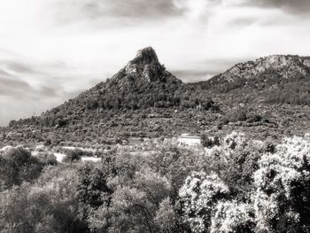 Scenic view of mountains against cloudy sky