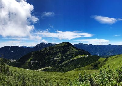 Scenic view of mountains against blue sky