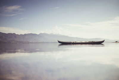 Boat on lake against sky