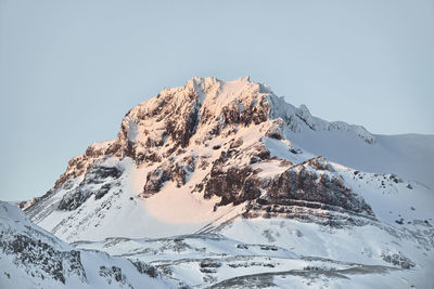 Scenic view of snowcapped mountains against clear sky