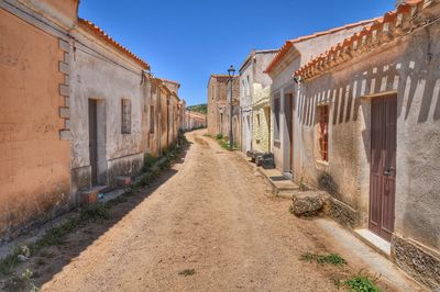 Street amidst buildings against clear sky