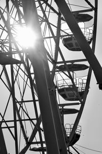 Low angle view of silhouette ferris wheel against sky