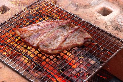 High angle view of meat on barbecue grill