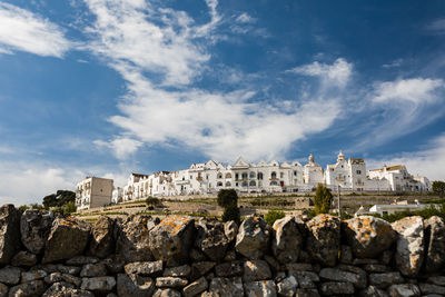 Buildings against cloudy sky