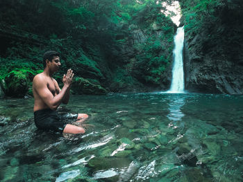 Man photographing in water