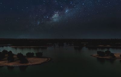 Scenic view of lake against sky at night