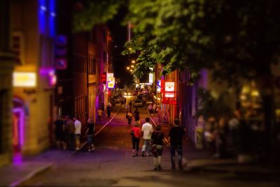 People in illuminated city at night