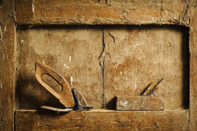 Close-up of old planes on weathered wooden niche