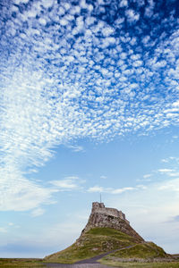 Low angle view of temple against cloudy sky