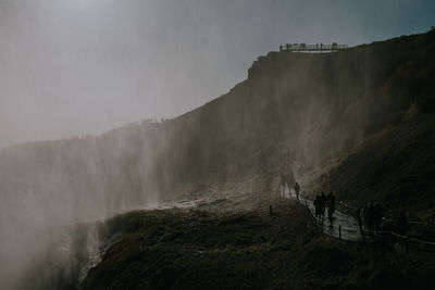 Scenic view of waterfall against sky