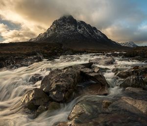 Scenic view of waterfall against sky