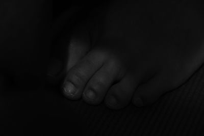 Close-up of human hand against black background