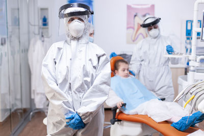 Midsection of doctor examining patient in hospital